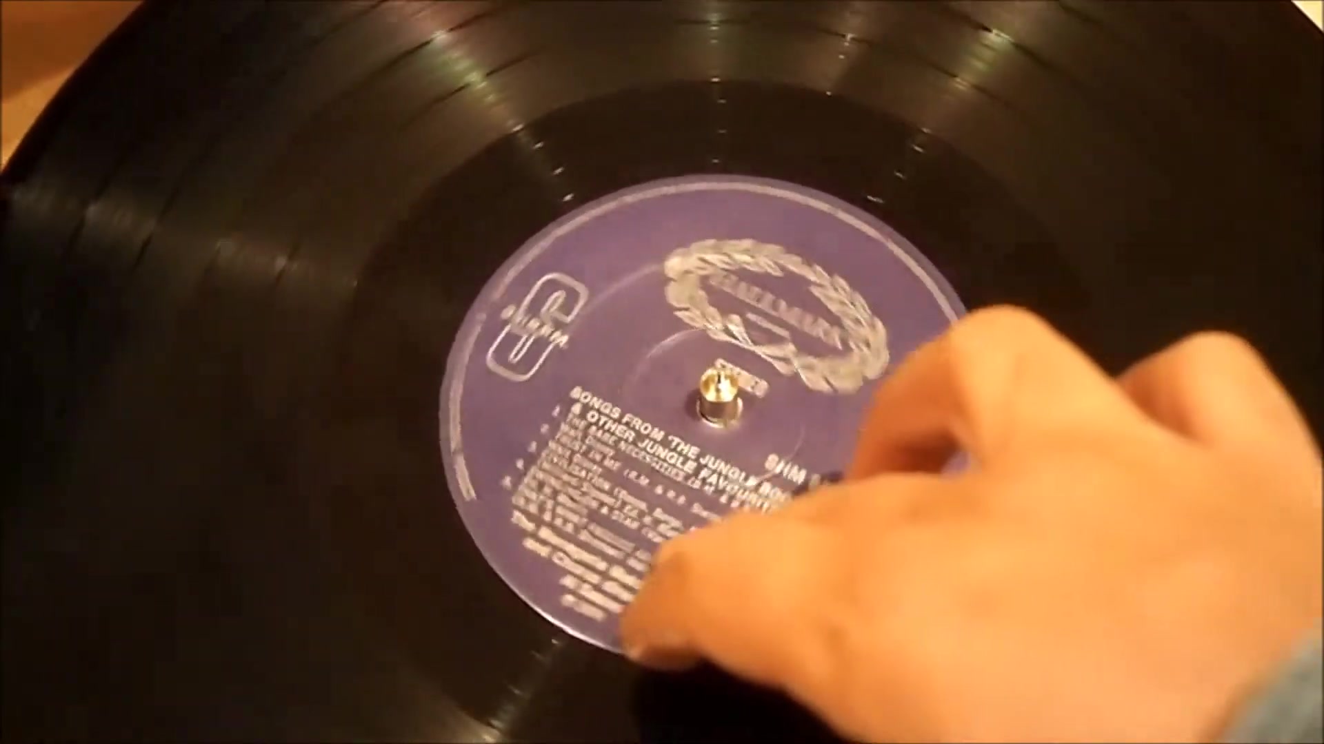 Hard drive platter playing 7-inch record with paper cone